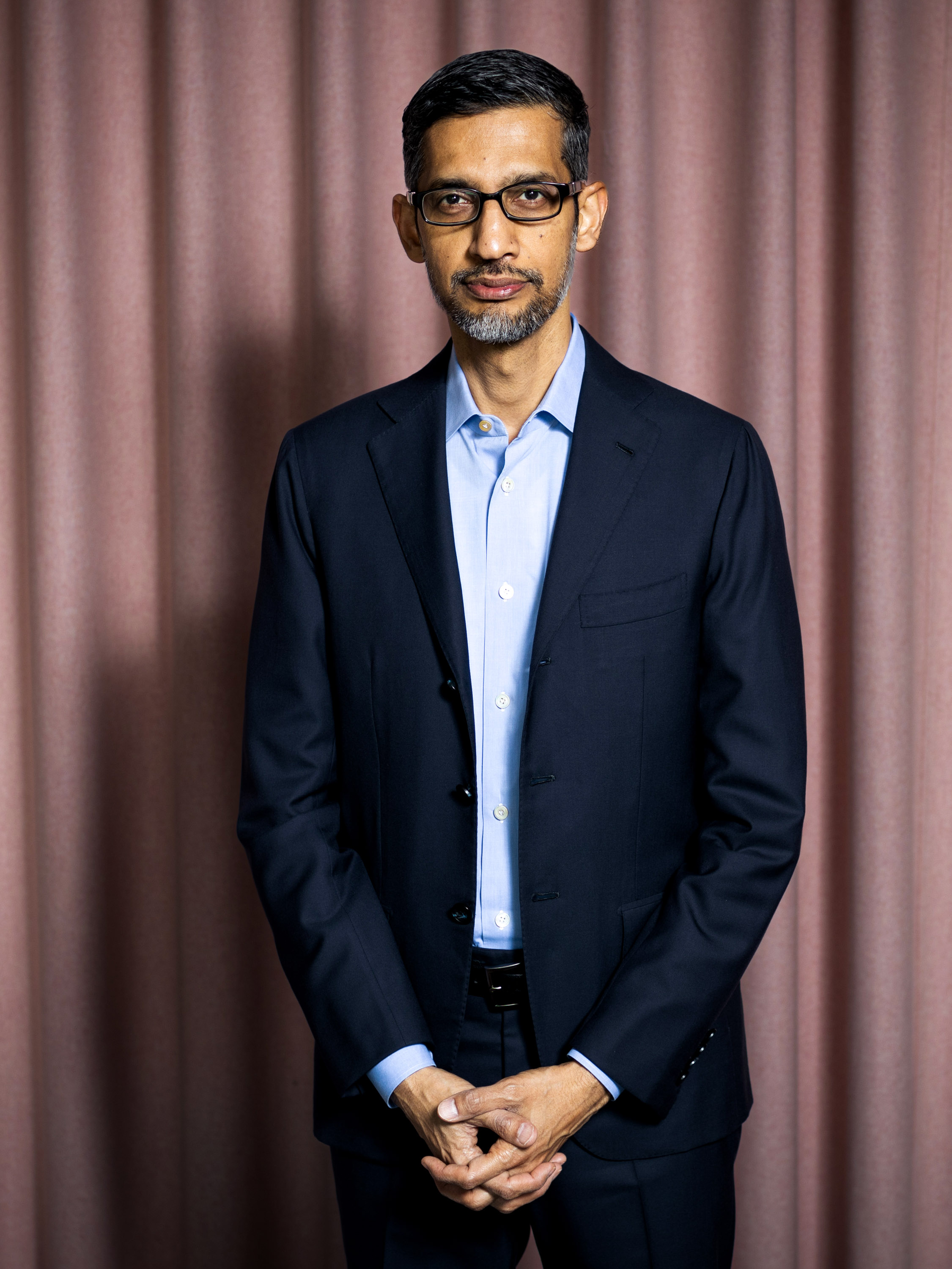 Sundar Pichai against a pink theatrical curtain